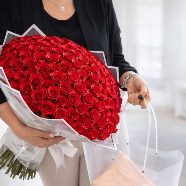 Large bouquet of red roses wrapped in white paper
