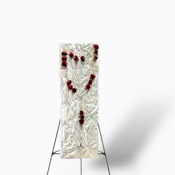 White funeral easel spray with red roses on a stand