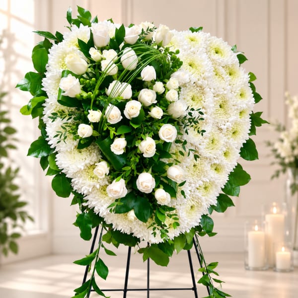 Heart-shaped white floral standing spray with roses and chrysanthemums