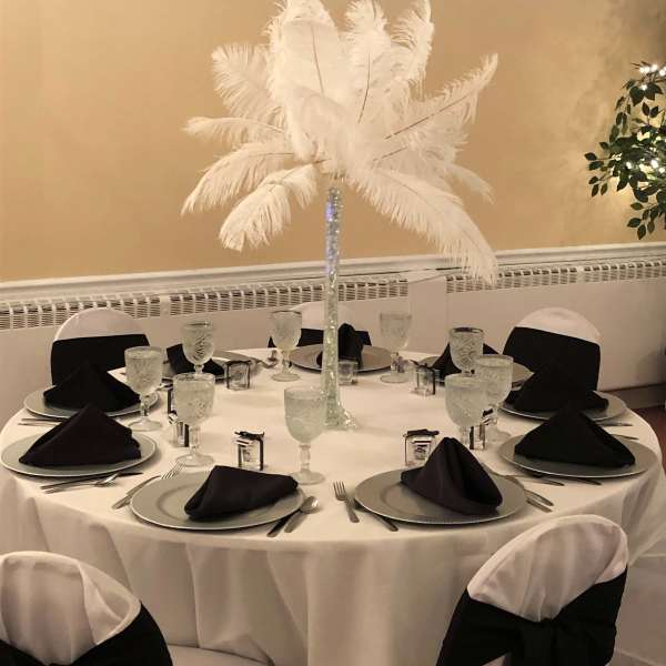 Tall white feather centerpiece on a banquet table