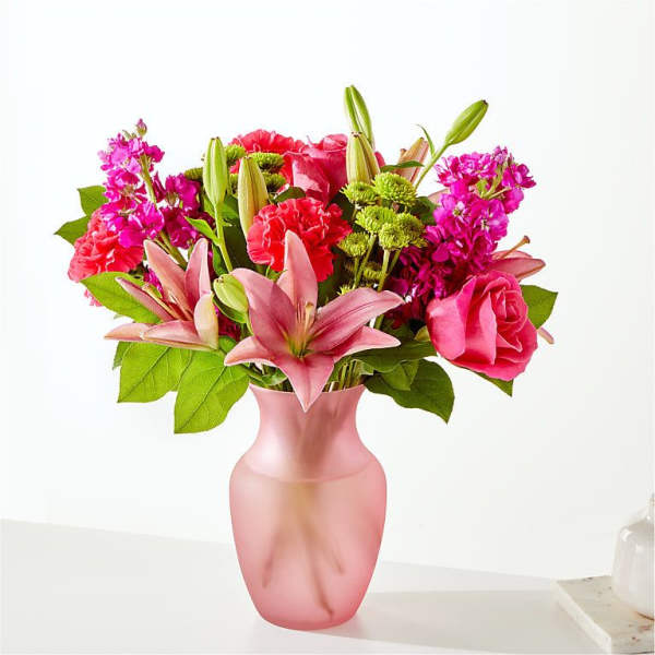 Pink and red mixed bouquet in a frosted pink vase