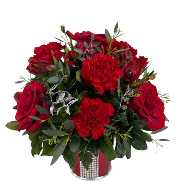 Red roses and carnations arranged in a red vase