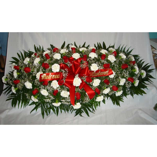 Sympathy floral spray with red roses and white carnations