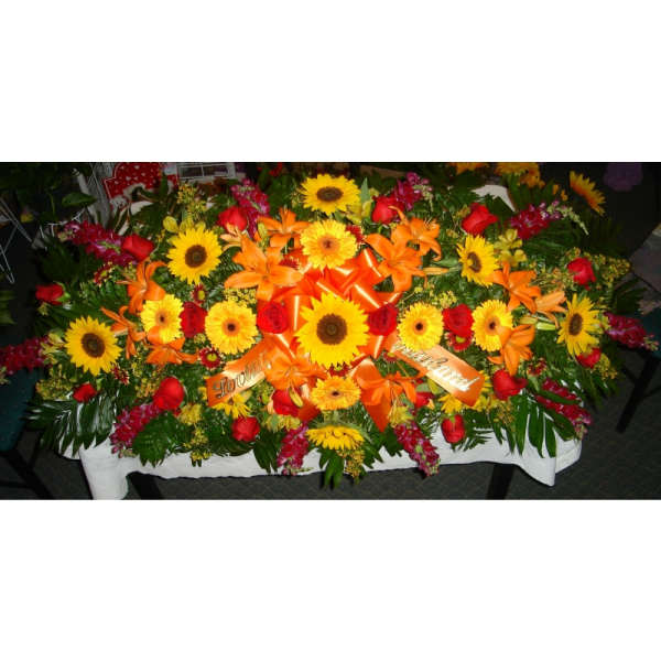 Casket Spray of Sunflowers, lilies, daisies, and snapdragons