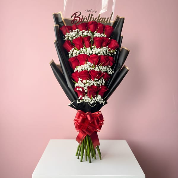 Bouquet of red roses with white baby's breath and a birthday topper
