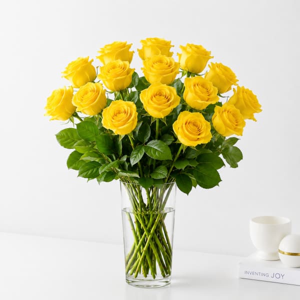 Yellow roses arranged in a clear glass vase