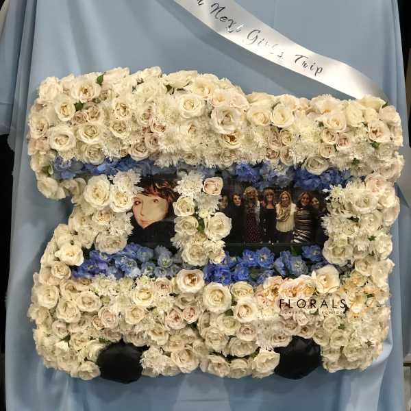 Floral photo frame with white roses and blue flowers around two pictures