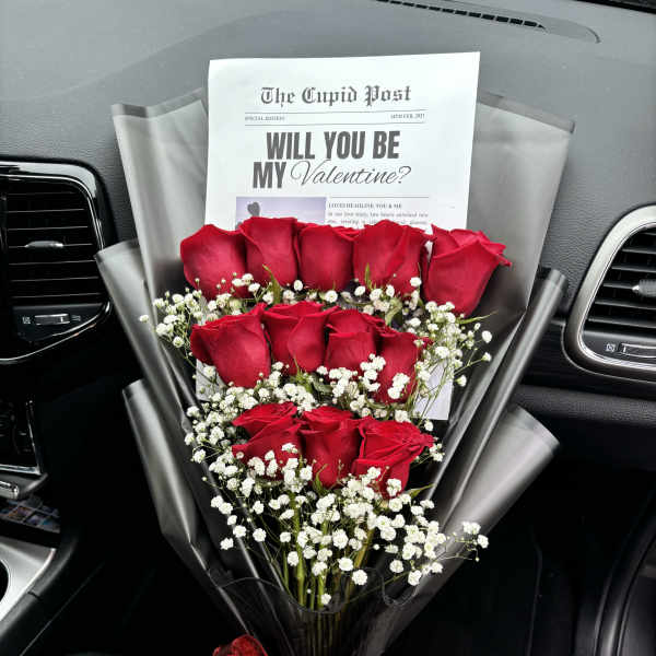 Bouquet of red roses with baby's breath and a red ribbon in a car seat