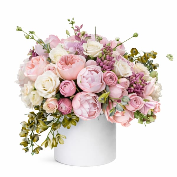 Pink and white rose bouquet in a white cylindrical vase