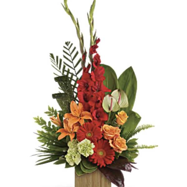 Tropical arrangement with red, orange, and green flowers in a wooden container