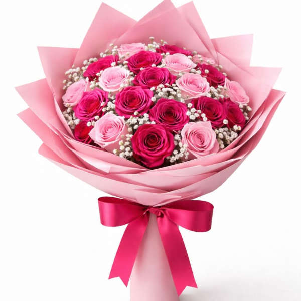 Bouquet of pink and red roses wrapped in pink paper with a ribbon