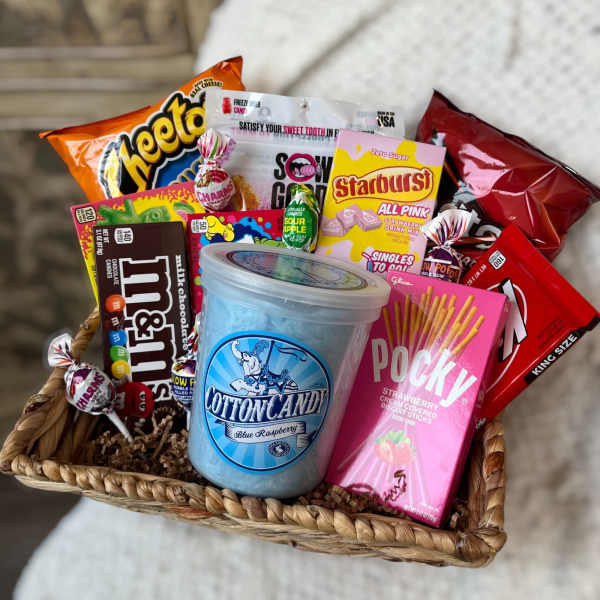 Basket of assorted candy and snacks with a cotton candy tub