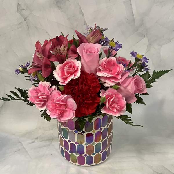 Pink and red mixed bouquet in a colorful mosaic vase