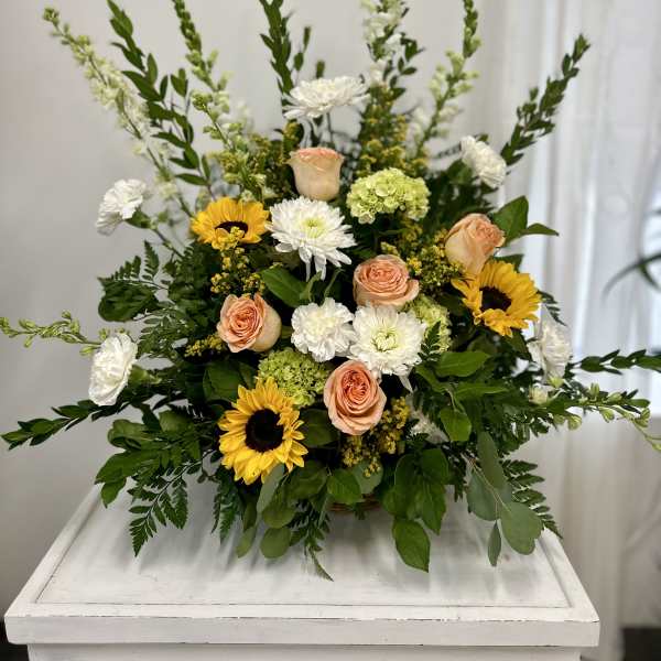 Mixed bouquet with sunflowers, peach roses, and white blooms