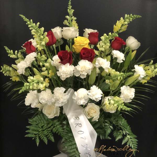 Large floral spray with red, white, and yellow roses and white carnations