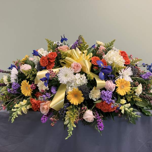 Large mixed floral arrangement with a yellow ribbon bow