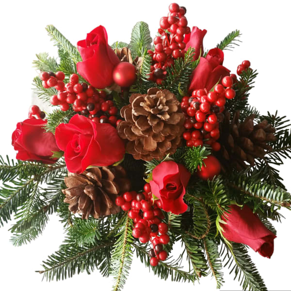 Red roses with pinecones and berries in a holiday bouquet