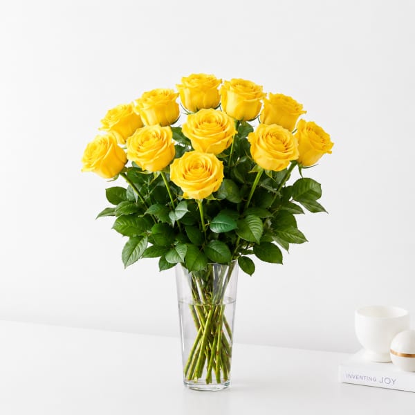 Yellow roses arranged in a clear glass vase