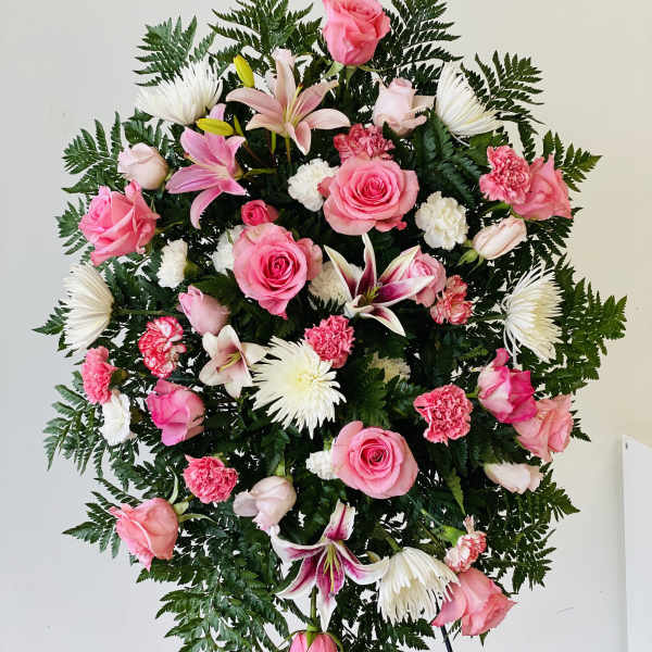 Standing floral spray with pink roses, lilies, and white chrysanthemums