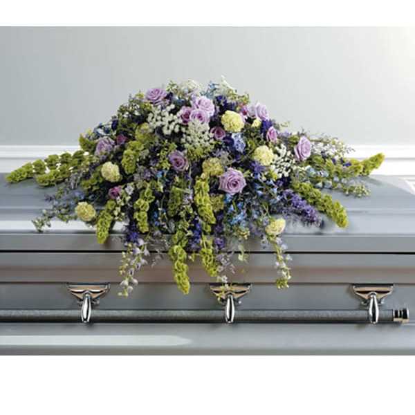 Lavender and white floral spray on a gray casket