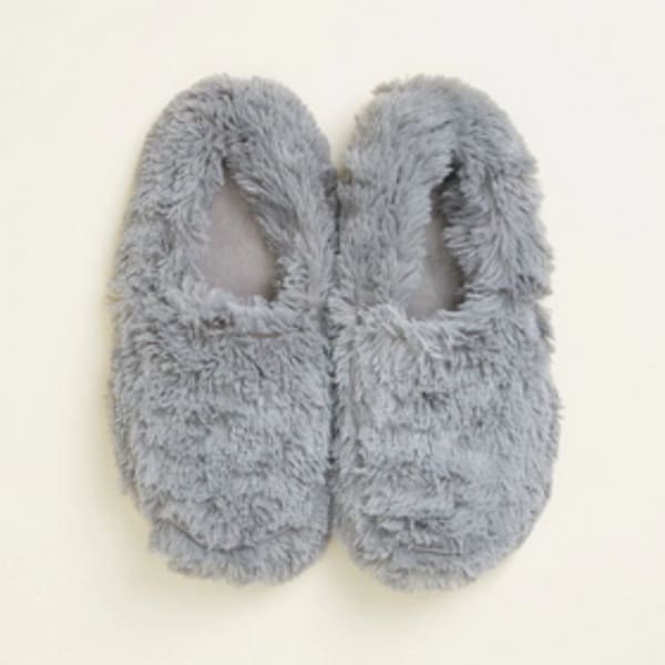 Pair of gray fuzzy slippers on a light background