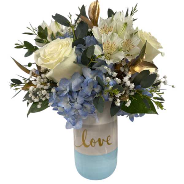 White roses and blue hydrangeas in a blue vase with "love" text