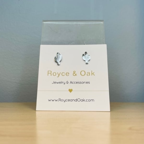 Pair of cactus-shaped stud earrings on a jewelry card