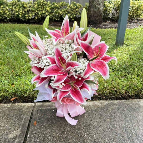 Pink and white lily bouquet with baby's breath and ribbon wrap