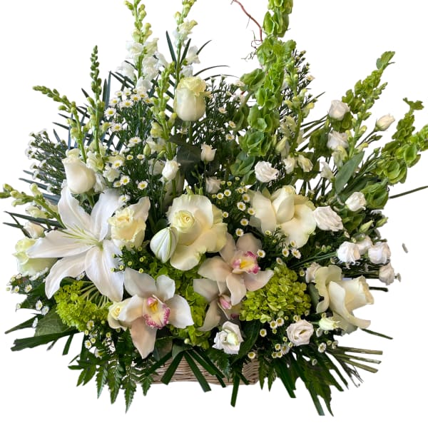 Large white floral arrangement in a basket with tall green spikes