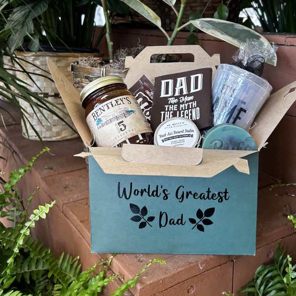 Gift basket with dad-themed snacks and grooming items in a teal box