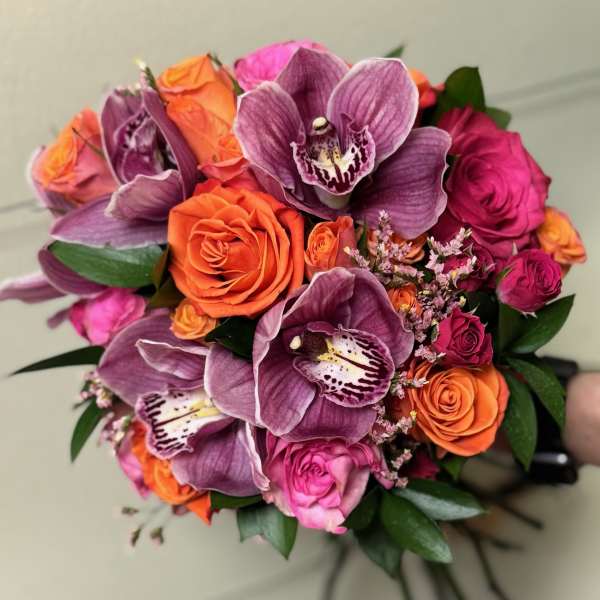 Bouquet of purple orchids and orange and pink roses