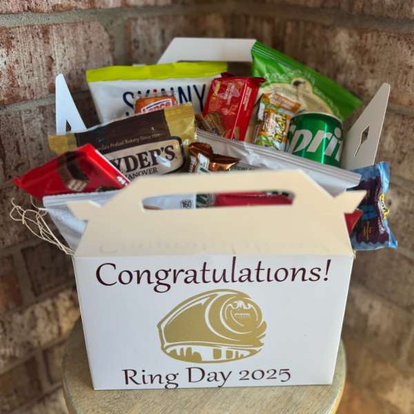 Gift box filled with assorted snack packs and a soda can