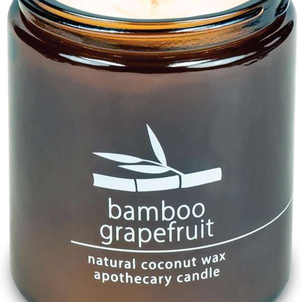 Brown glass candle jar labeled bamboo grapefruit