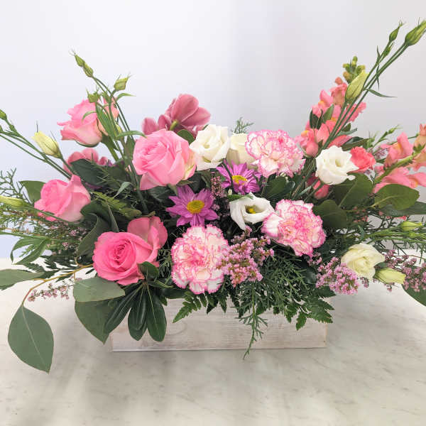 Pink and white mixed flower arrangement in a rectangular wooden box