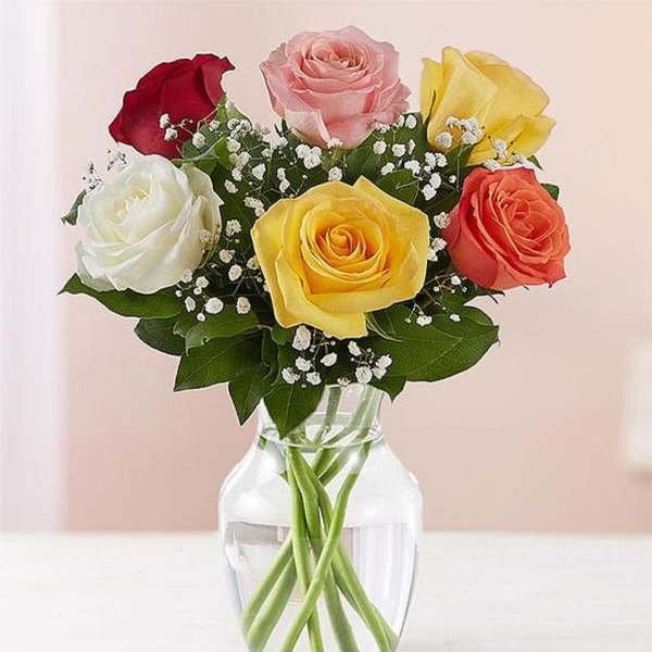 Bouquet of multicolored roses in a clear glass vase