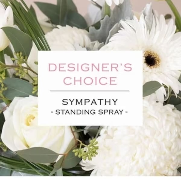 White sympathy standing spray with mixed blooms and greenery