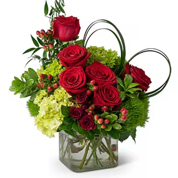 Red roses and green hydrangeas in a square glass vase