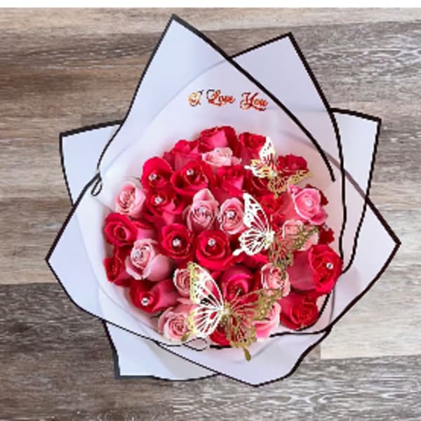 Bouquet of pink and red roses wrapped in white paper