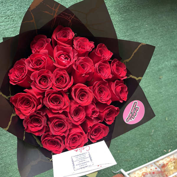 Bouquet of red roses wrapped in black paper