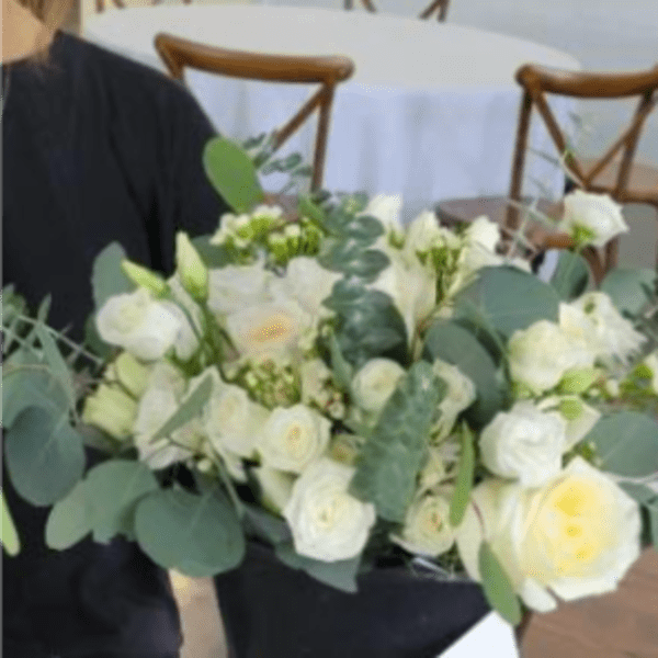 White rose bouquet with eucalyptus in a black wrap