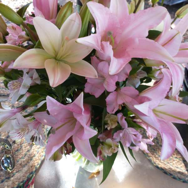 Bouquet of pink and white lilies with small striped accent flowers