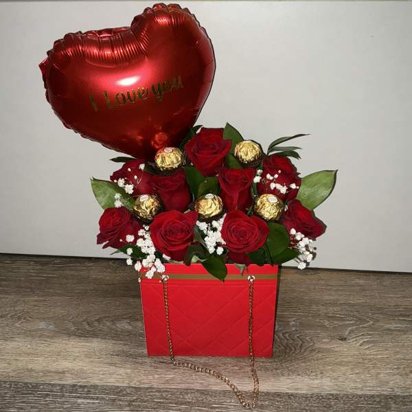 Red rose arrangement in a red gift box with a heart balloon and chocolates