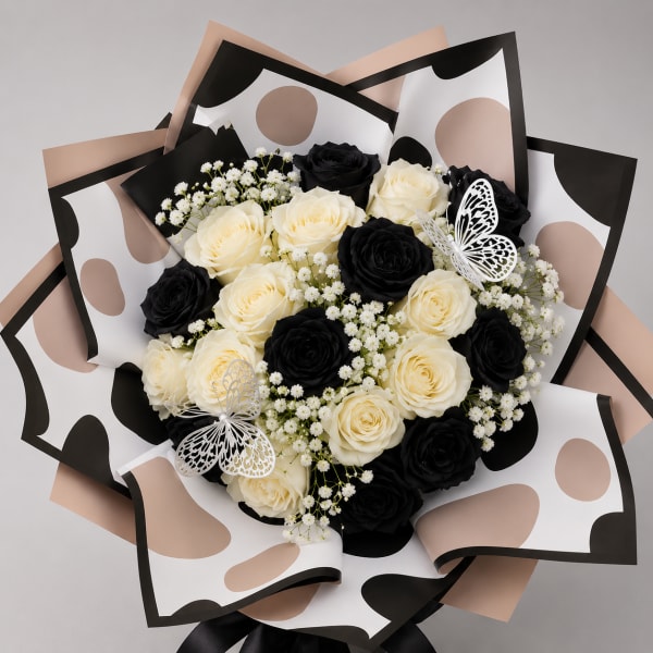 Bouquet of black and cream roses with baby’s breath and butterfly accents