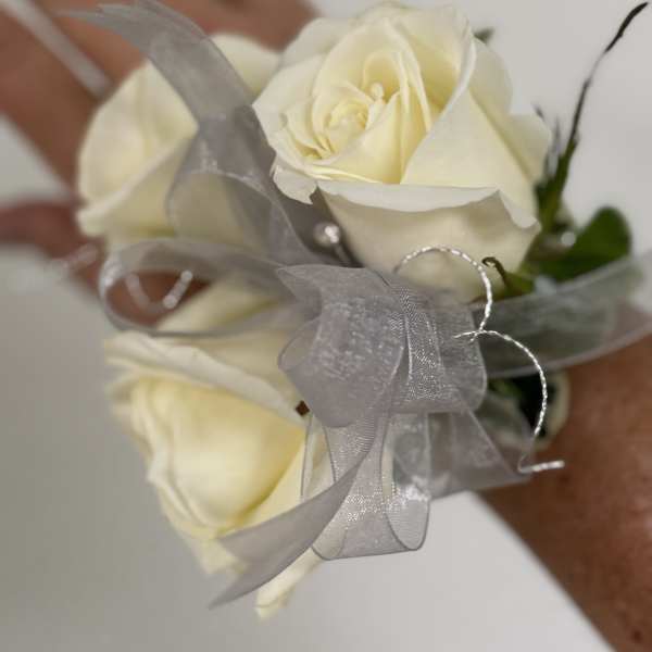 Small bouquet of cream roses with a silver ribbon