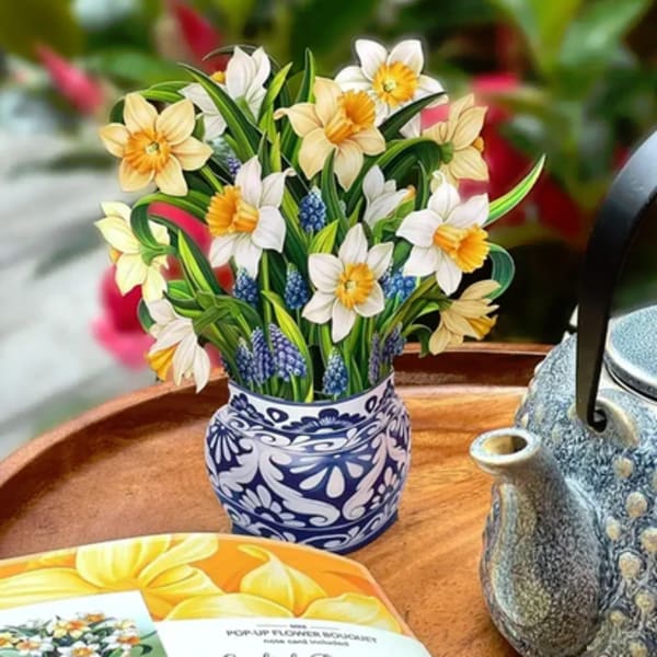 Pop-up bouquet of daffodils in a patterned vase