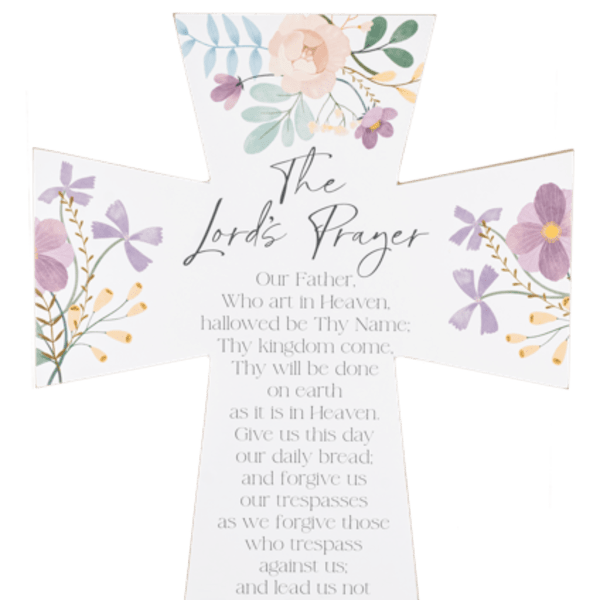 White cross-shaped sign with floral accents and the Lord's Prayer text