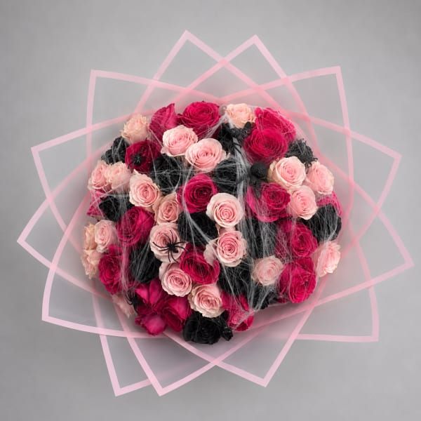 Round bouquet of pink and black roses with pink geometric wrap