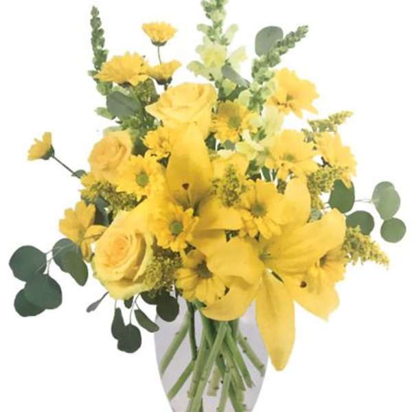 Yellow mixed bouquet in a clear glass vase