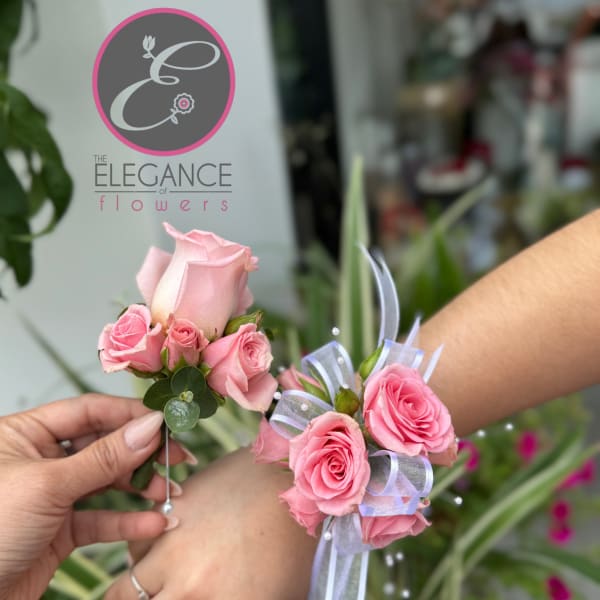 Pink rose corsages with ribbon accents held in hands