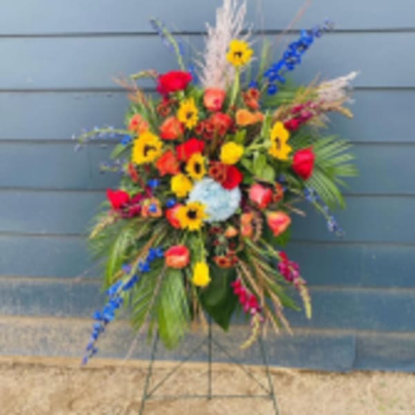 Tall colorful floral standing spray on a metal easel